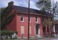 s mill street july 1969 red building with two floors and two boarded up windows on the left bottom floor.