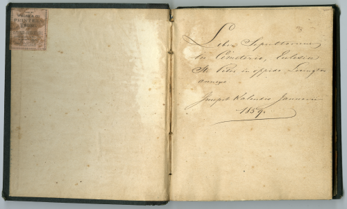 Two page book spread with a stamp on the left hand side and Latin text on the right hand side that means "Book of those buried in the St. Peter church cemetery in the City of Lexington. Written the first of January 1859."