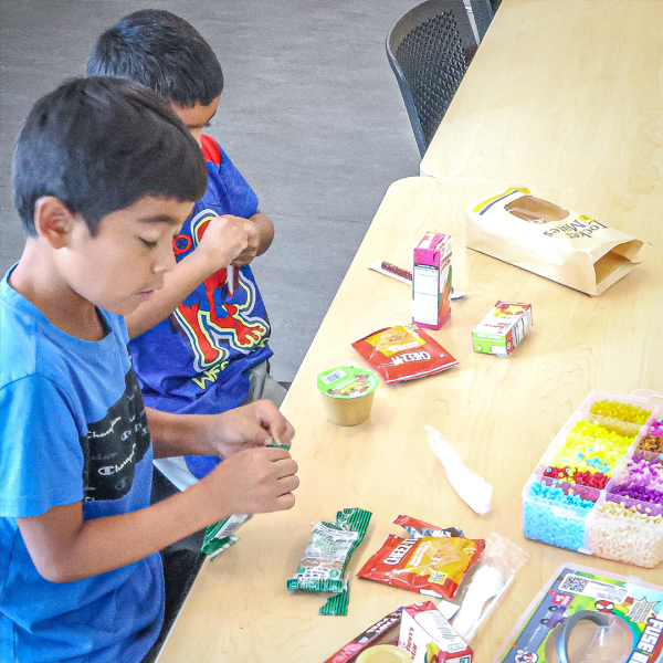 Two young people with snacks at the library