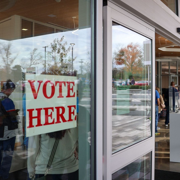 Sign that reads "VOTE HERE" is on the glass door at the Marksbury Family Branch