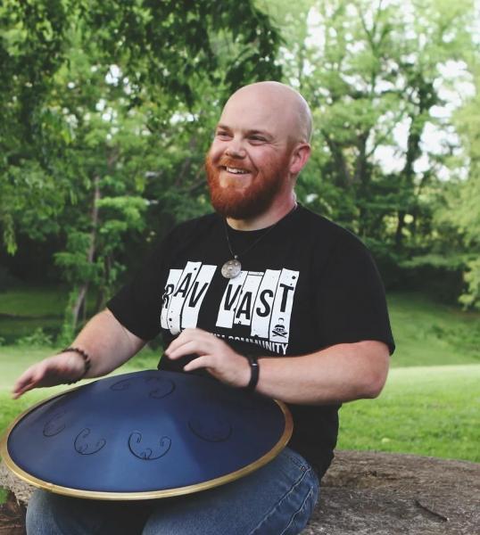 Pete Wallace smiling with hand pan.