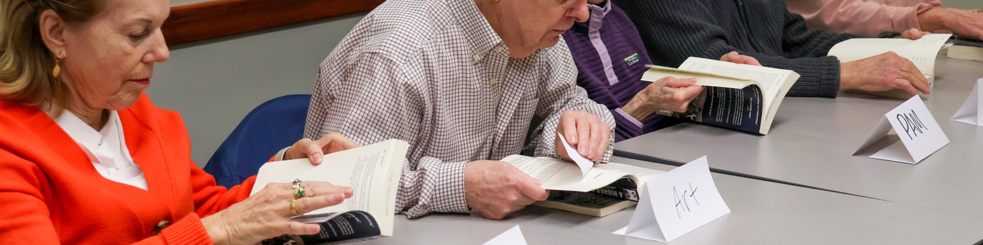 Services: group of adults look at reading materials