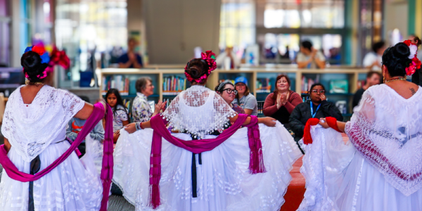 Participants gather to watch a local dance troupe perform.