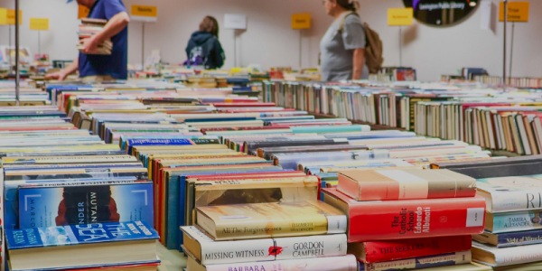 Thousands of books, DVDs, and more on tables in the Friends Book Cellar