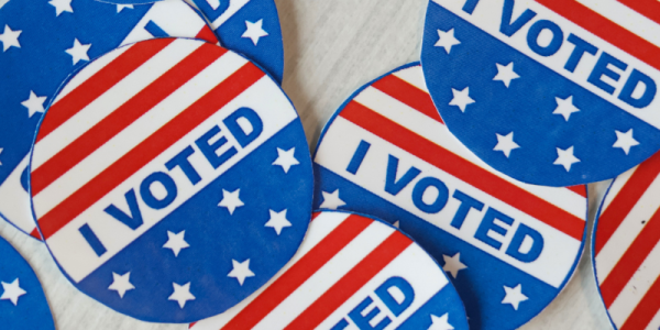 "I Voted" stickers messily sit on a table 