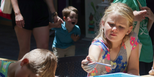 Children color at a library table.